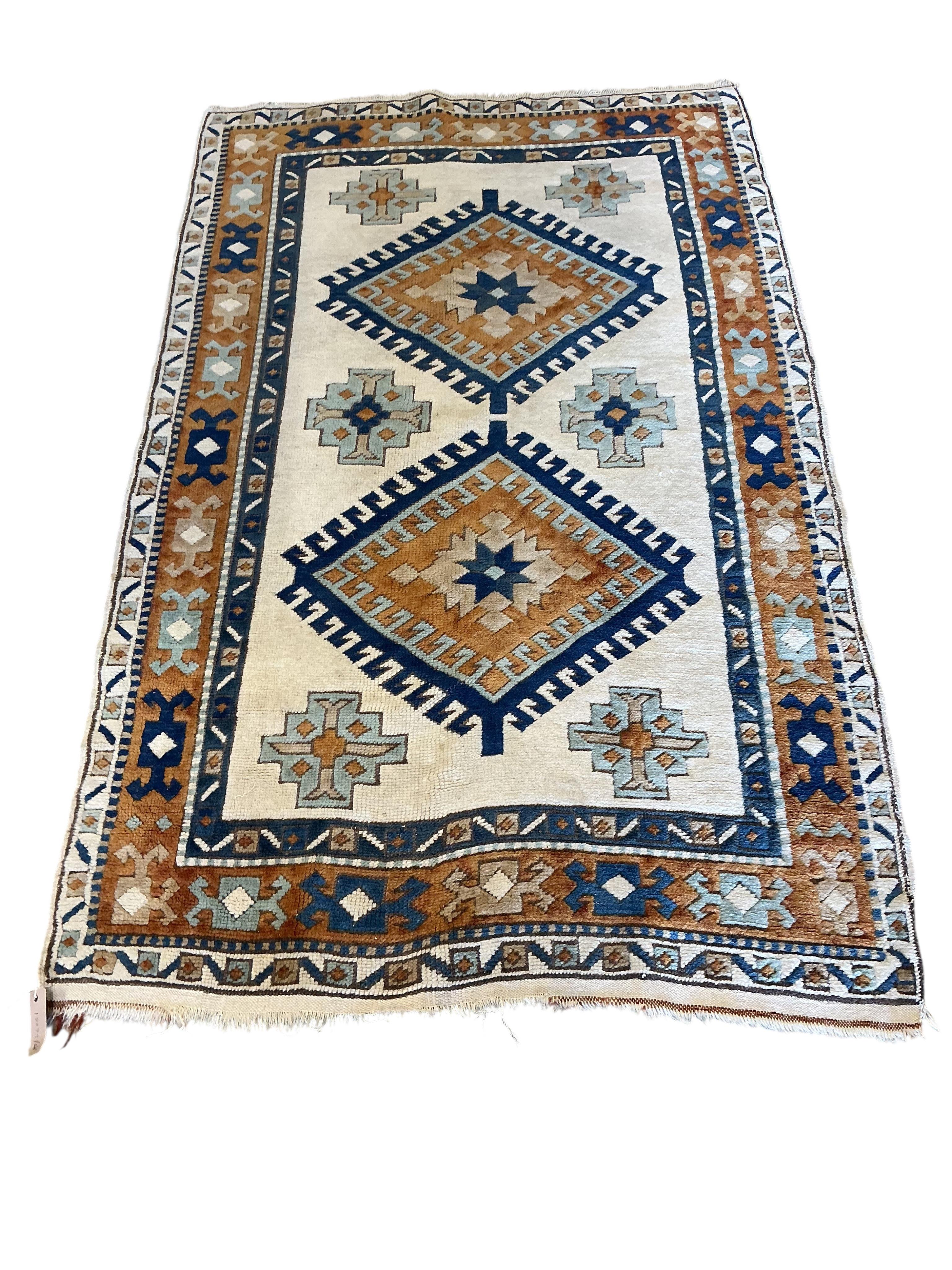 A Caucasian style ivory ground rug, 158 x 98cm